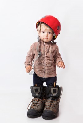 A little girl in the big boots.
